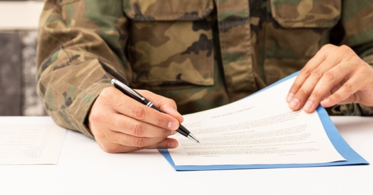 military person checking a document