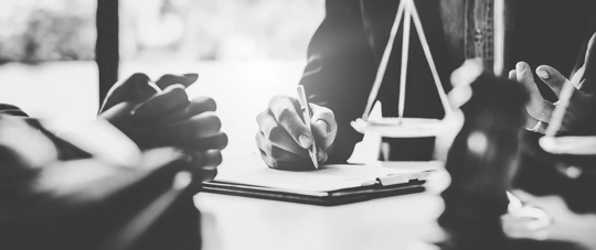 Black and white photo of attorney meeting with client